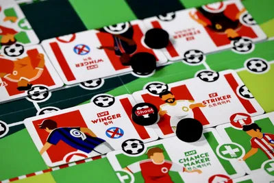 Players placing cards and building tactics in Magic Number Eleven, the strategic football board game from Korea.