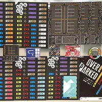 All components of Overparked, including vehicle tiles, player boards, objective cards, and steering wheel.
