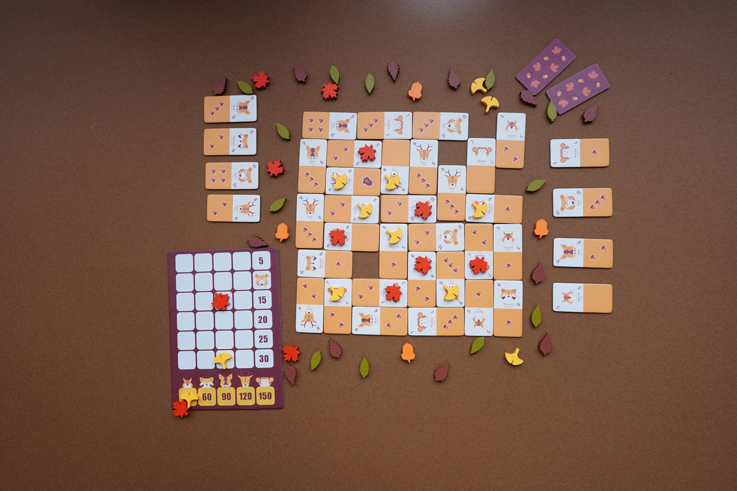 Acornism prepared for play with animal and acorn tiles placed on the board.