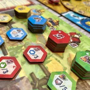 Players stacking tiles and defending castles in Castle Raisers, the strategic fairy tale game from Taiwan.