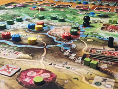 Players swapping workers, building citadels, and battling Romans in Celtae, the ancient city-building game.