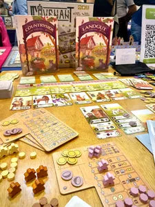 Countryside gameplay – farmers placing cards to expand their farm