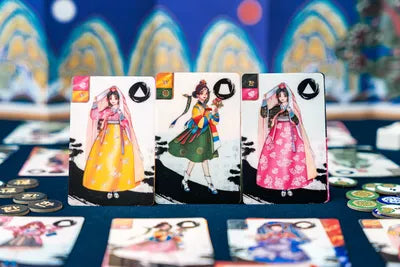 Hanbok Runway prepared for play with fabric and style cards laid out on the table.