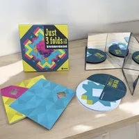 All components of Just 3 Folds, including patterned origami papers and puzzle cards.