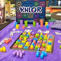 All components of Khlor, including polyomino tiles, Demon Tokens, dragon eggs, and player boards.