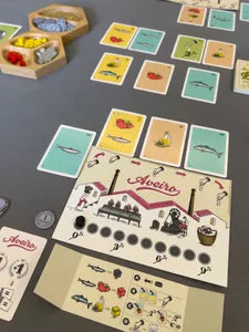 Players bidding, producing, and selling preserves in Lata, the strategic canning board game from Portugal.