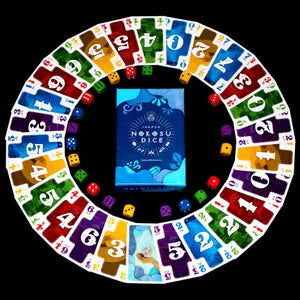 All game materials – All Nokosu Dice components including number cards, dice, and score markers.