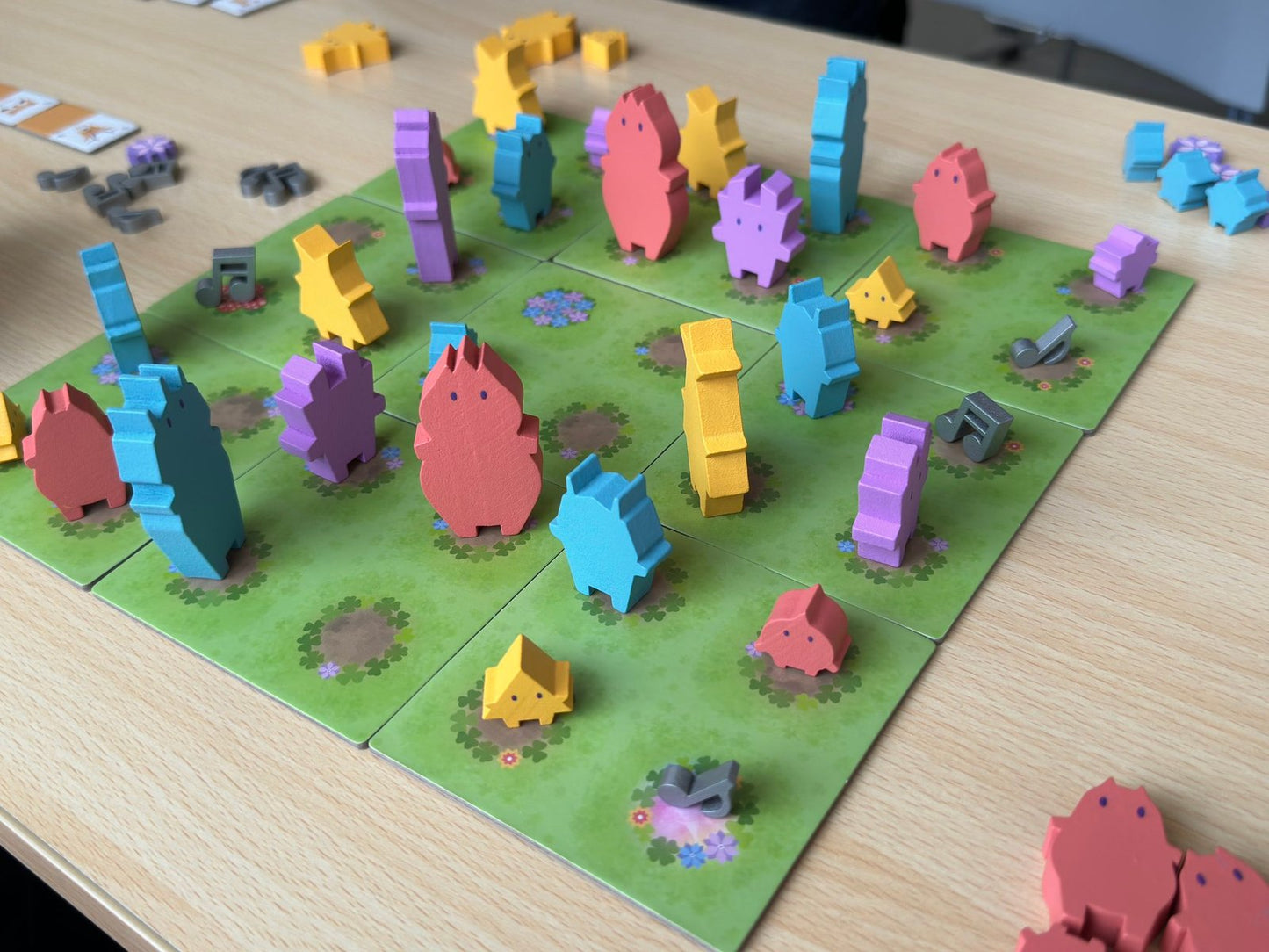 Players placing gnome tiles and forming palindromic patterns in PalinGnomes.