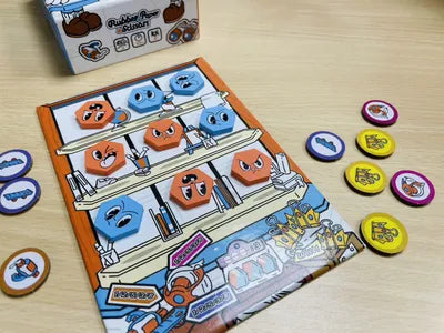 Rubber Paper Scissors arranged for play with cards and shop window components ready.