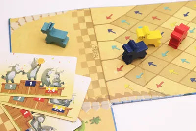 All components of Run, Mule, Run!, including mule tokens, track board, colored arrows, and secret goal cards.