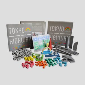 All game components of Tokyo Highway: Rainbow City laid out (roads, cars, city objects, rulebook, etc.).
