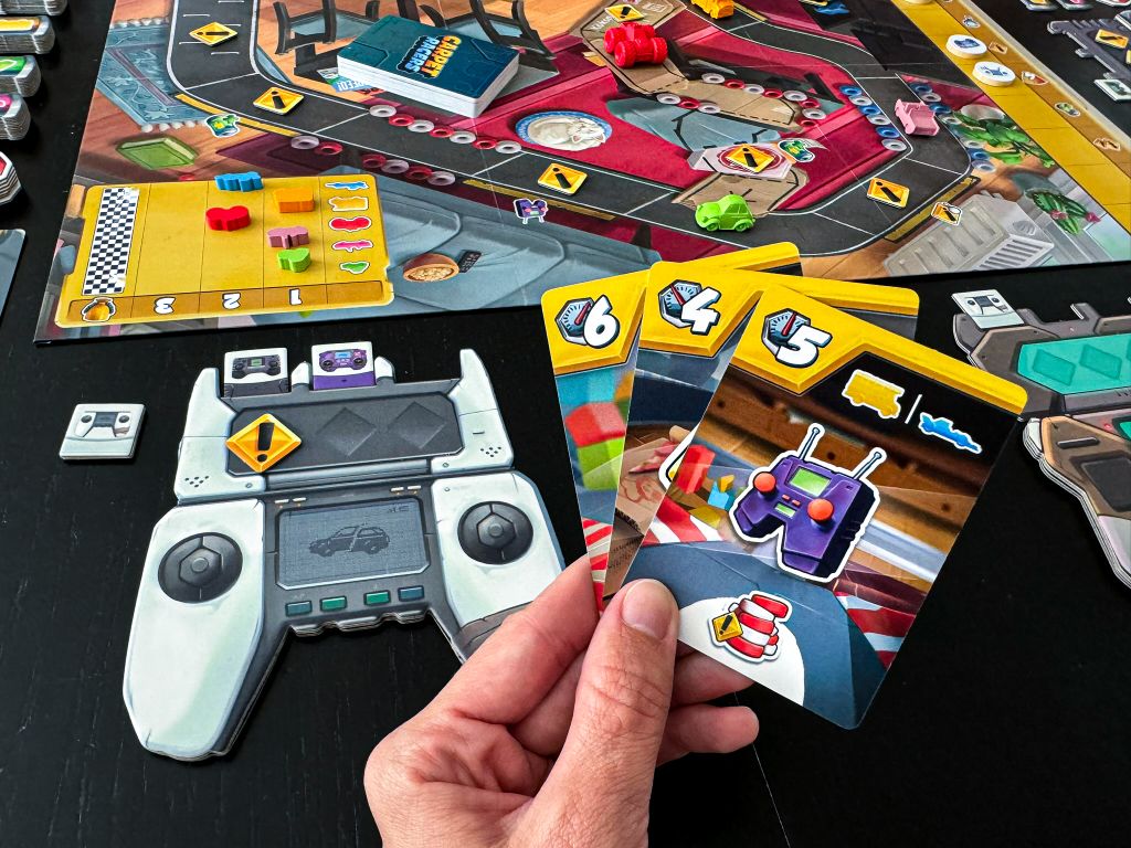 Carpet Racers — hand of movement cards with a controller and the track