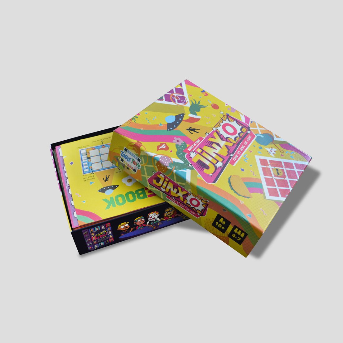 JinxO word cards, tokens, and scoreboard pieces displayed
